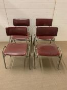 Four vintage Mid Century tubular frame stacking chairs with red seat pads