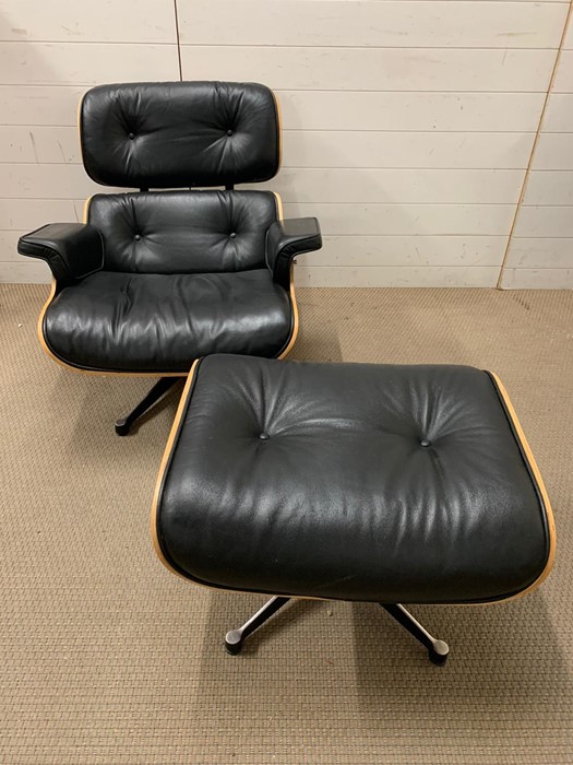 A rosewood lounge chair and ottoman. After Charles and Roy Eames for Herman Milner with black - Image 3 of 9