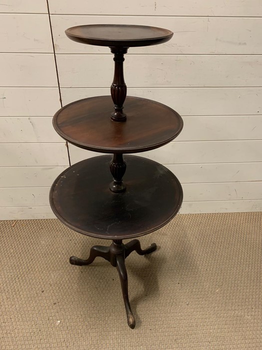 A Georgian style mahogany dumb waiter with three trays (H104cm Dia47cm)