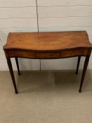 A mahogany tea table on reeded tapering legs (H70cm W93cm D99cm opened)