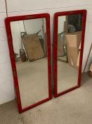 A pair of wall mirrors in red and oriental theme gilding to sides (110cm x 46cm)