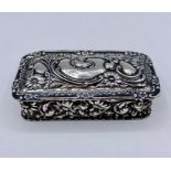 A small silver repoussé lidded pot (8cm x 4cm)