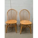 A two Mid Century stick back chairs.