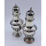 A pair of silver cruets (64g) by James Dixon & Sons Ltd (12cm tall)