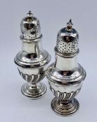 A pair of silver cruets (64g) by James Dixon & Sons Ltd (12cm tall)