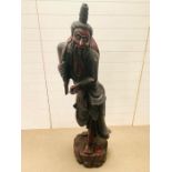 A wooden carved oriental statue (153cm/5ft)