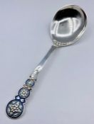 A Norwegian silver and enamel spoon (17 cm long and 50g).