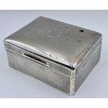 A silver cigarette box, hallmarked London 1919 by CLS