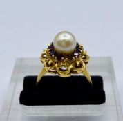 An 18ct gold, pearl and ruby ring (6.8g) Total weight, one missing stone.