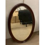 A mahogany oval wall mirror (97cm x 60cm)