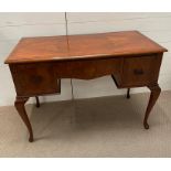 An Art Deco walnut desk with two side drawers (109 cm w x 54 cm d x 76cm h)