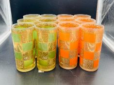 Twelve vintage tumbler glasses, orange, green glass with gilt decoration