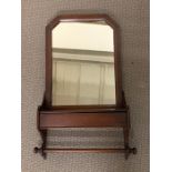 A mahogany shaving wall mirror