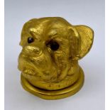 A gilt cast ink well top or bottle top of a dog