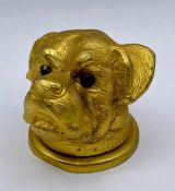 A gilt cast ink well top or bottle top of a dog