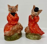 A pair of Staffordshire figurines of foxes Mr and Mrs fox in hunting attire