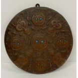 A small decorative shield in a Mesopotamia style