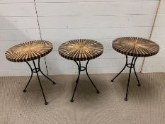 A trio of contemporary side tables on metal legs