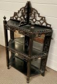 An Ebonised wall hanging shelving rack