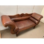 A New York style mahogany and leather sofa with scrolling ends and studs, two leather bolsters (