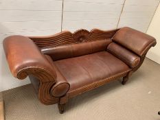 A New York style mahogany and leather sofa with scrolling ends and studs, two leather bolsters (