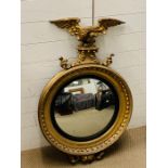 A regency giltwood convex wall mirror with ball surmounted frame headed by an eagle (H105cm W65cm)