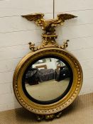 A regency giltwood convex wall mirror with ball surmounted frame headed by an eagle (H105cm W65cm)