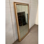 A twelve panel glass wall mirror (91cm x 167cm)