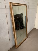 A twelve panel glass wall mirror (91cm x 167cm)