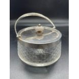 A Silver lidded and handles glass biscuit barrel.