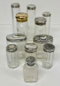 A selection of eleven various glass bottles with hallmarked silver tops