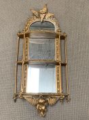 A George II style giltwood wall mirrored shelves with flowers and fern leaves with gilt wood rods to