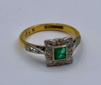 An 18ct gold and platinum emerald and diamond ring Size K