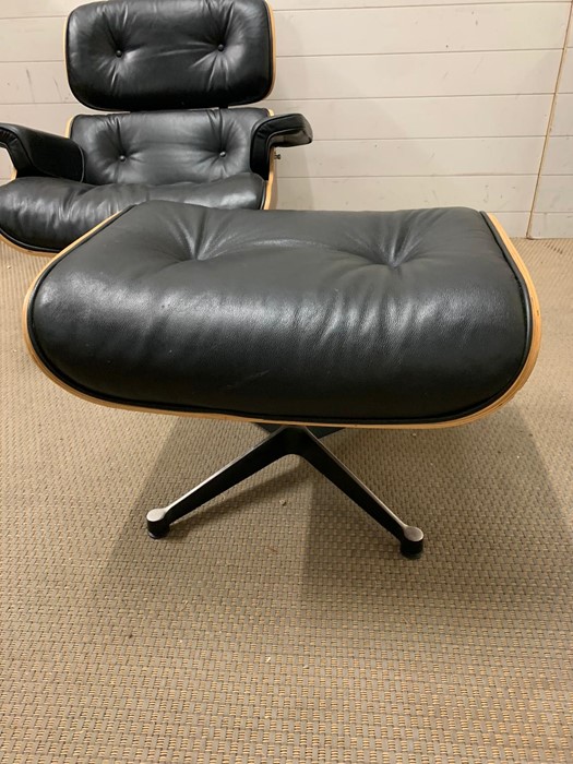 A rosewood lounge chair and ottoman. After Charles and Roy Eames for Herman Milner with black - Image 2 of 9