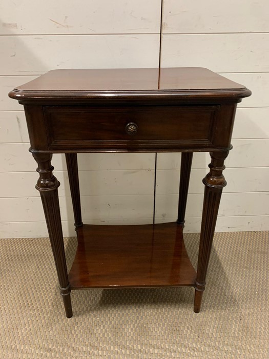 A mahogany side table on flute legs (H76cm W55cm D42cm)