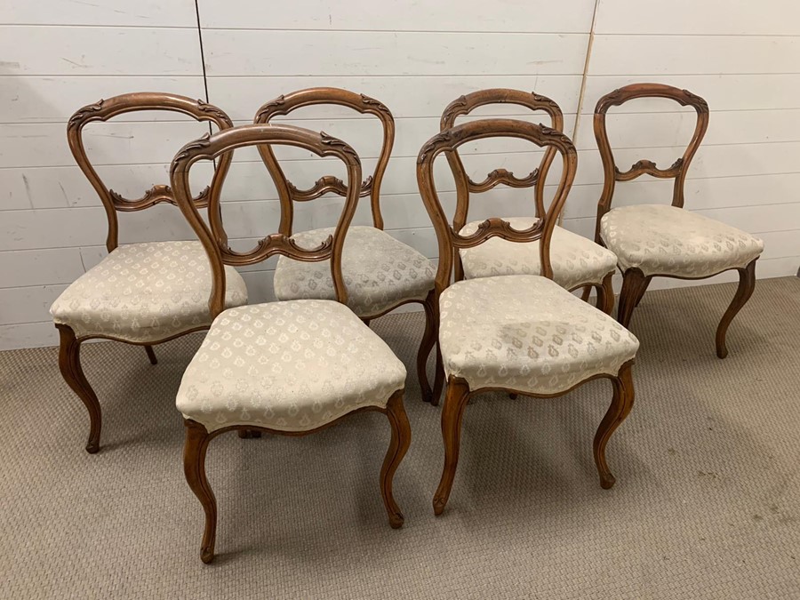 A set of six balloon back chairs on cabriole legs.