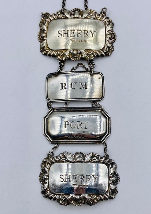 A selection of four hallmarked silver decanter labels, two sherry, port and rum.