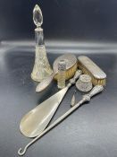 A selection of silver items to include silver scent bottles, silver backed mirrors etc.