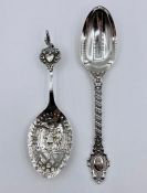 Two silver spoons, one Victorian the other on stand is Continental.