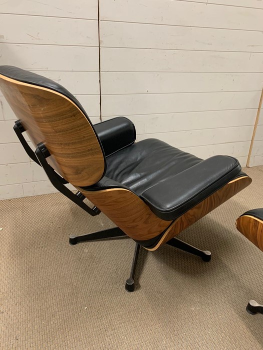 A rosewood lounge chair and ottoman. After Charles and Roy Eames for Herman Milner with black - Image 5 of 9