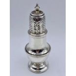 A silver sugar shaker by C S Harris & Sons Ltd, hallmarked London 1915 (12cm tall)