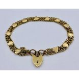 A 9ct gold bracelet with heart shaped fastener and safety chain (Total weight 10.6g)