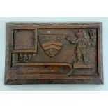 A small antique carved wooden desktop marked 1387 with an unknown coat of arms
