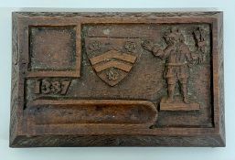 A small antique carved wooden desktop marked 1387 with an unknown coat of arms
