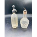 Two cut glass miniature bar bottles, one cordial bottle with white metal sprout and one miniature