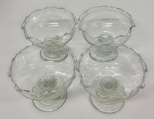Four glass dishes with twisted stem
