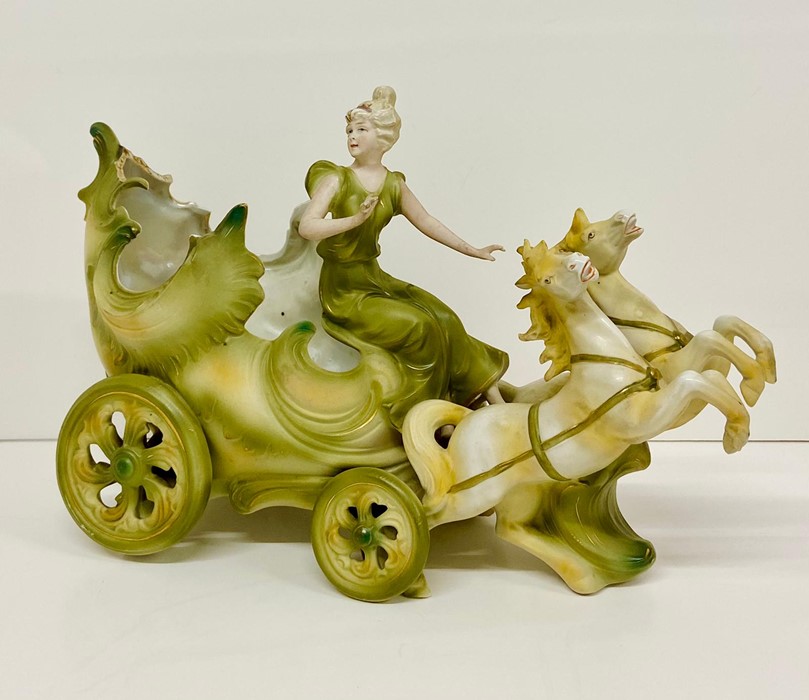 A fairy-tale themed figure of a girl and a carriage AF