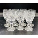 A set of seven cut glass sherry glasses