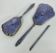 A white metal and enamel part dressing table set.