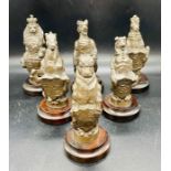 Six large carved chess pieces